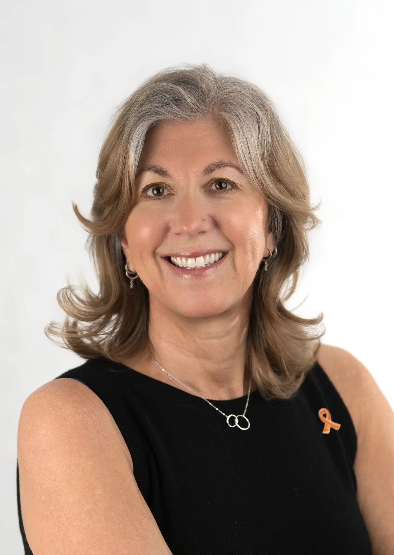 Clean corporate headshot of a smiling silver-haired executive on a white studio background, CT