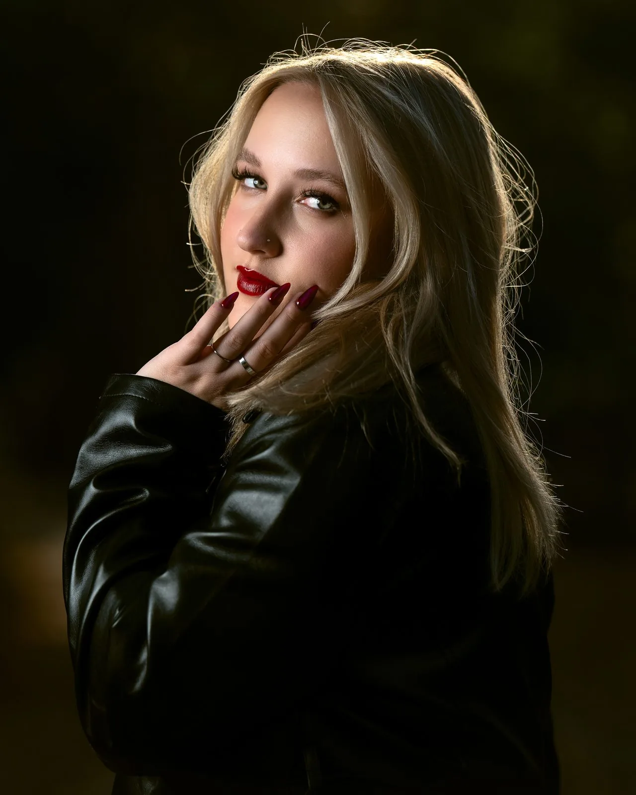 Backlit golden-hour portrait of a blonde woman in a leather jacket with red lips — portrait photography in East Haven CT