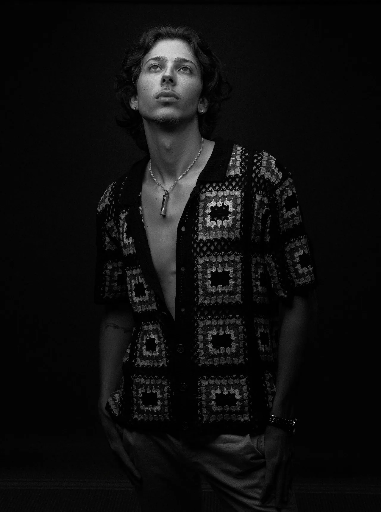 Moody black and white editorial portrait of a young man looking into the light, Connecticut studio