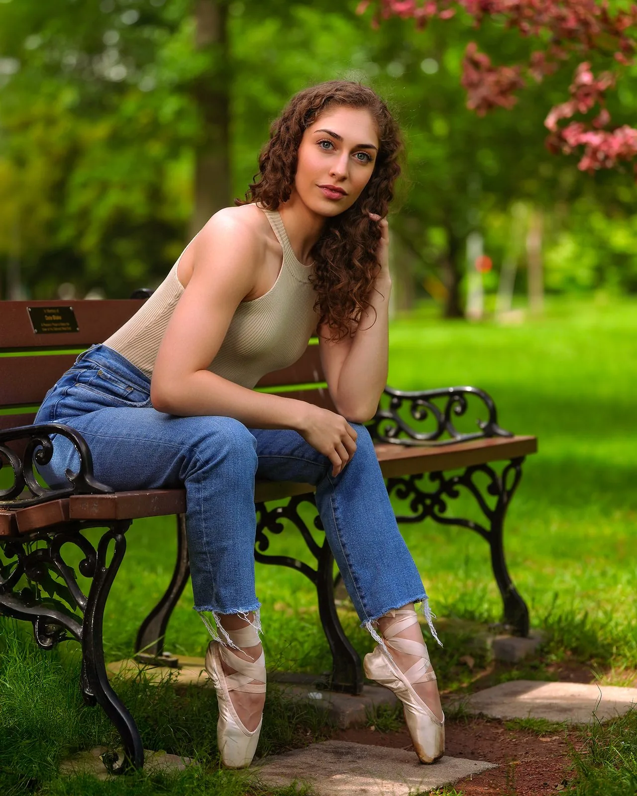 High school senior portrait of a ballet dancer on pointe by a park bench, New Haven County CT